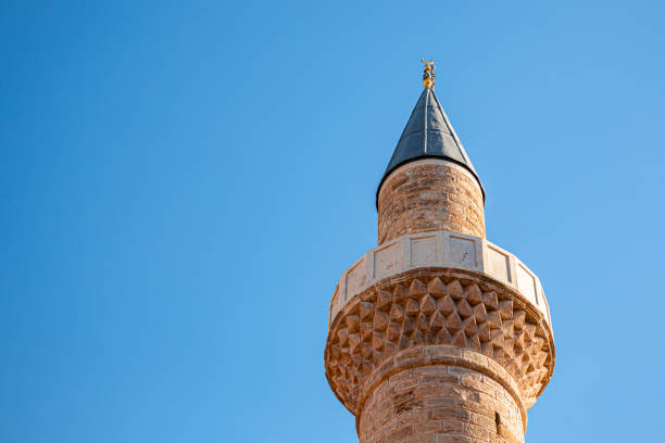 This historic Ottoman-era mosque minaret in Antalya features stunning stone craftsmanship, constructed with durable travertine and lime materials. The tower, with its timeworn beauty, stands as a remarkable example of ancient architecture, offering a glimpse into the rich cultural heritage of the Ottoman Empire. Its elegant design and weathered appearance make it a standout landmark in southern Turkey.