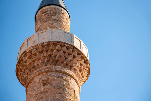 This historic Ottoman-era mosque minaret in Antalya features stunning stone craftsmanship, constructed with durable travertine and lime materials. The tower, with its timeworn beauty, stands as a remarkable example of ancient architecture, offering a glimpse into the rich cultural heritage of the Ottoman Empire. Its elegant design and weathered appearance make it a standout landmark in southern Turkey.
