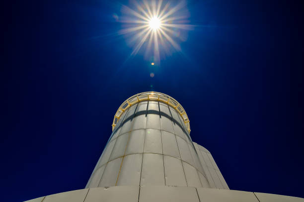 istock A tall white tower with a bright sun shining on it 2184807245