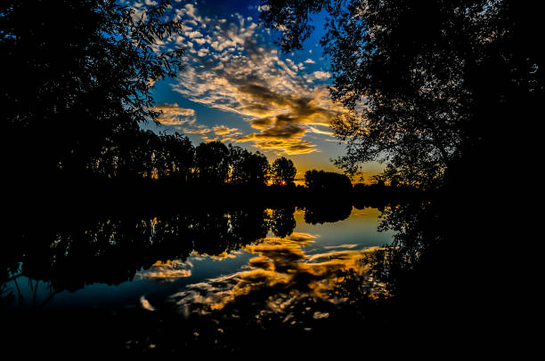 istock A beautiful sunset over a lake with trees in the background 2184807300