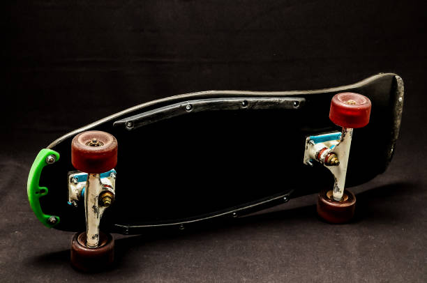 istock A skateboard with green wheels is laying on a black surface 2184807320