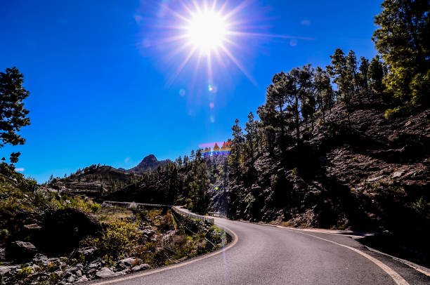 istock A road with a sun shining on it 2184807412