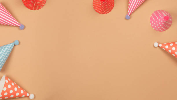 Colorful birthday cap on brown  background. Copy space.