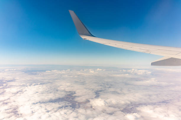 istock View from the airplane window at a beautiful cloudy sky and the airplane wing 2184808963