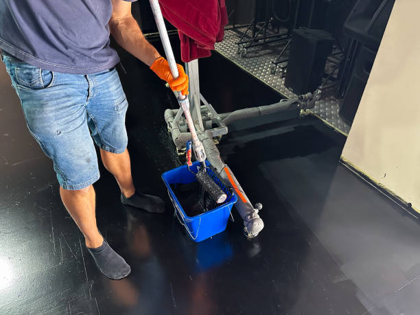 istock Man technical service worker painting the stage of a theater 2184810540