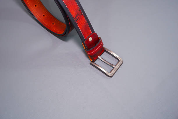 istock Brown leather belt isolated on grey background close-up view 2184810998