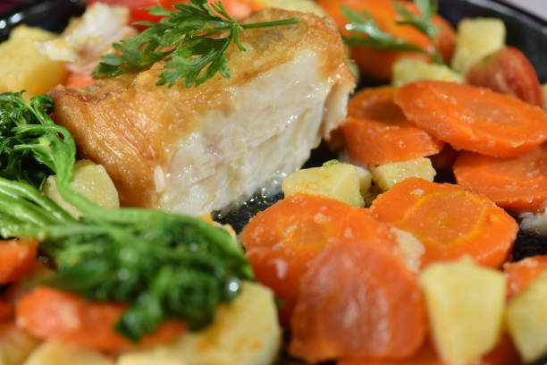 istock codfish typical Portuguese dish baked cod with onion garlic peppers and potatoes rustic Portuguese food salted fish cooked olive oil 2184811693