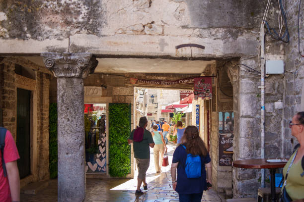 Trogir, Croatia; September 23, 2024: A bustling stone passage in Trogir, Croatia, lined with shops and cafes, showcasing historical architecture and local culture.