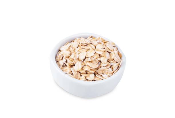 istock Raw dried oats in a bowl on a white isolated background 2184812223