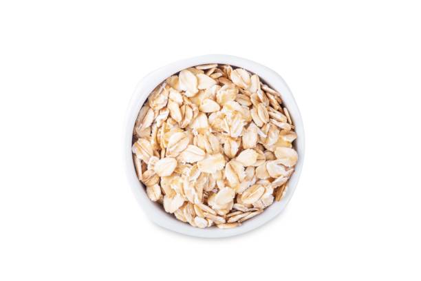 istock Raw dried oats in a bowl on a white isolated background 2184812226