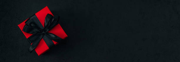 istock Red gift box with black satin ribbon 2184812451