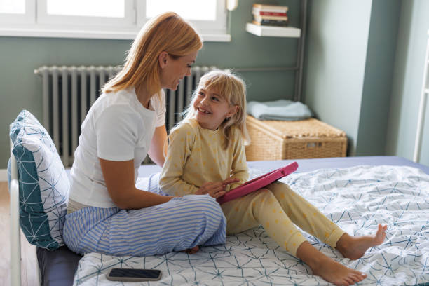istock Mother-daughter bonding over digital tablet 2184814448