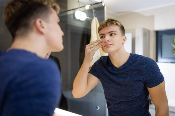 istock Young Man Practicing Daily Grooming Routine in the Bathroom Mirror 2184814541