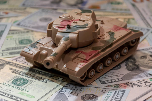 istock Military tank, American dollar bills. 2184815265