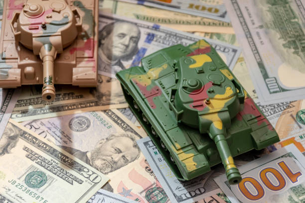 istock Conceptual photo: tanks on dollars, displaying military investments 2184815326