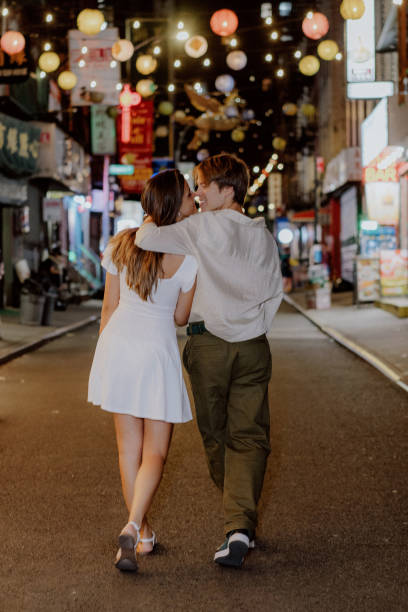 istock A couple strolls through a romantic urban night, enjoying a lively atmosphere and charm 2184815331