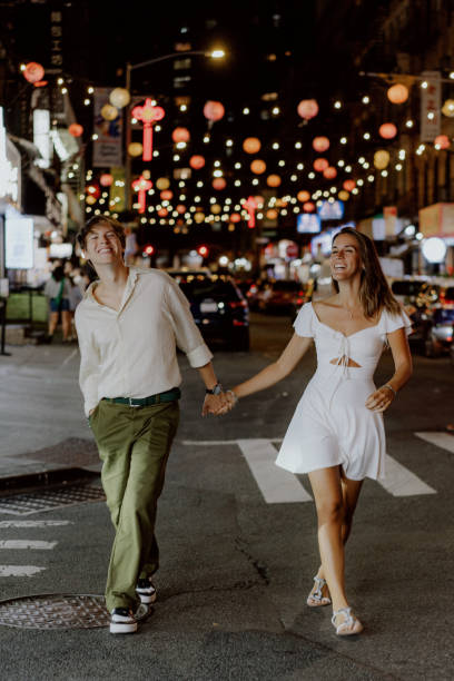 istock Charming couple strolling under festive city lights, fully embracing their special moment 2184816247