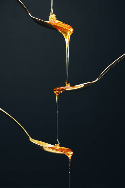 istock Honey Slowly Dripping on the Spoon 2184816435