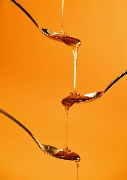 Honey Slowly Dripping on the Spoon