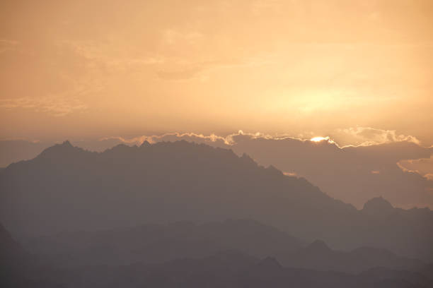 Sunset landscape with dark mountain peaks in egyptian desert.