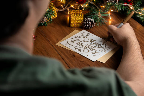 istock Writing a Merry Christmas Card with Festive Decorations 2184817861