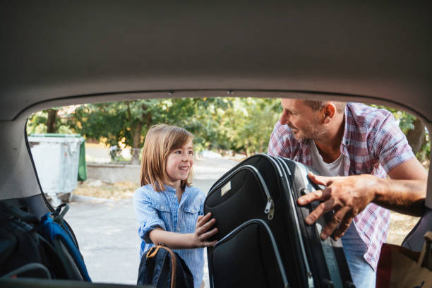 istock Father and son load car, sharing joyful travel moment. 2184824474
