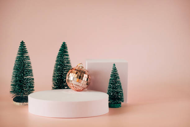 istock Empty geometric platform podiums for Christmas, New year product advertising. Blank platform stand on pale pink background with small Christmas trees and decorations 2184826060