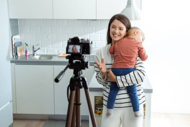 istock Mother and child creating video content in modern kitchen 2184826767