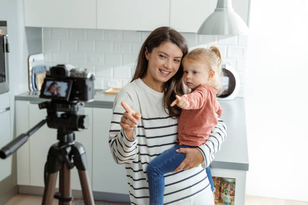 istock Mother and child creating video content in modern kitchen 2184826768