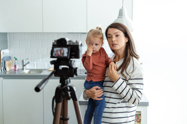 istock Mother creating video content with her daughter at home 2184826821