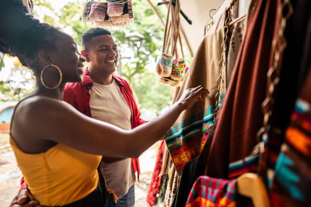 istock Tourist couple choosing clothes in a store 2184827889
