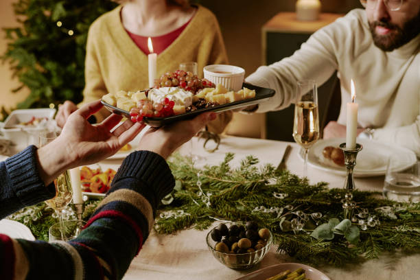 istock Unrecognizable Friend Offering Cheese Plate 2184829476