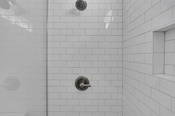 istock White Tiled Shower Wall With Metallic Shower Head 2184831201