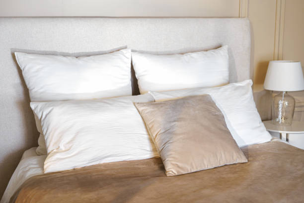 istock Cozy bedroom setting with plush pillows and soft bedding during daylight hours 2184835654