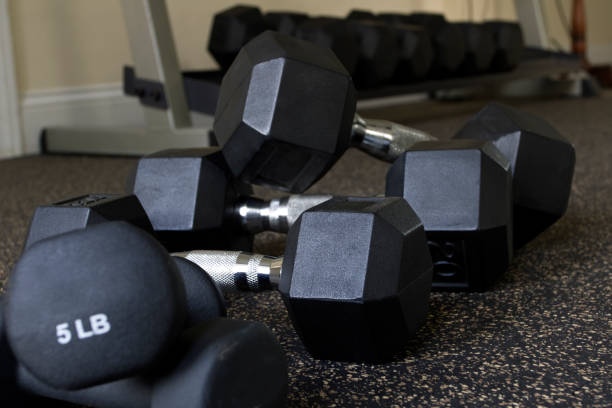 istock Dumbbells stacked on gym floor 2184839091