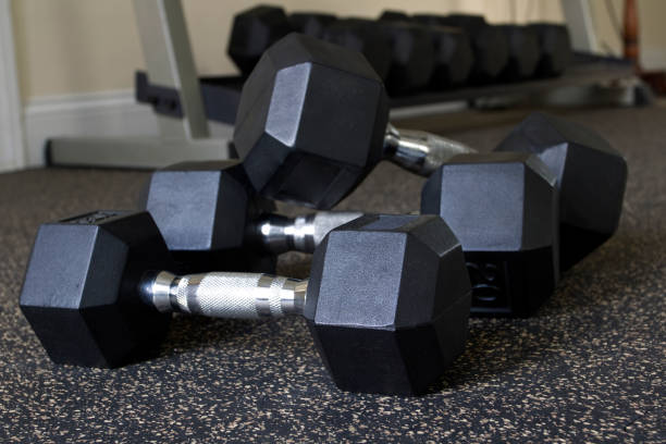 istock Dumbbells on health club floor 2184839096