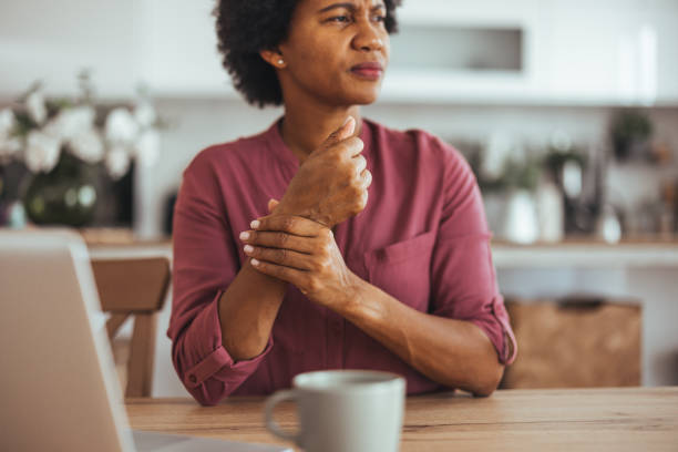 Woman Experiencing Wrist Pain While Working at Home