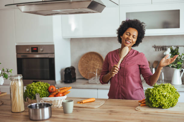 istock Woman Joyfully Cooking and Singing in the Kitchen 2184839239