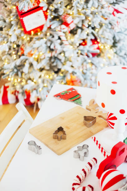 istock Festive baking setup with cookie cutters and decorated Christmas tree 2184840262