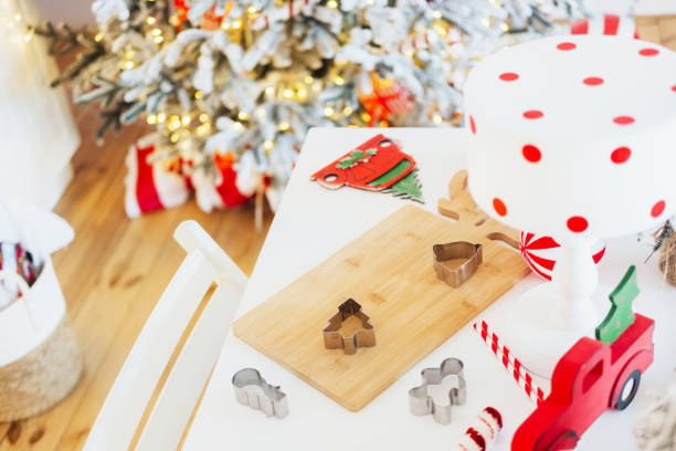 Festive kitchen setup with cookie cutters and decorated Christmas tree