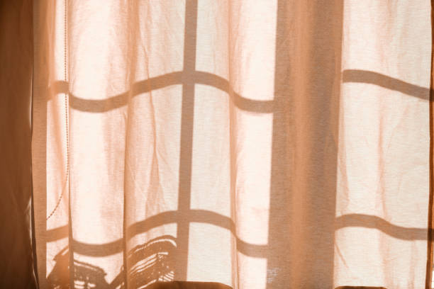 istock Soft sunlight filtering through sheer curtains in a cozy indoor space 2184840623