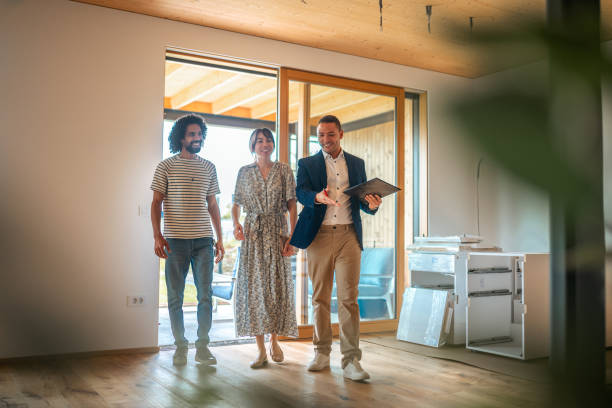 istock Hispanic Real Estate Agent Guiding Diverse Clients in Home Viewing 2184841768