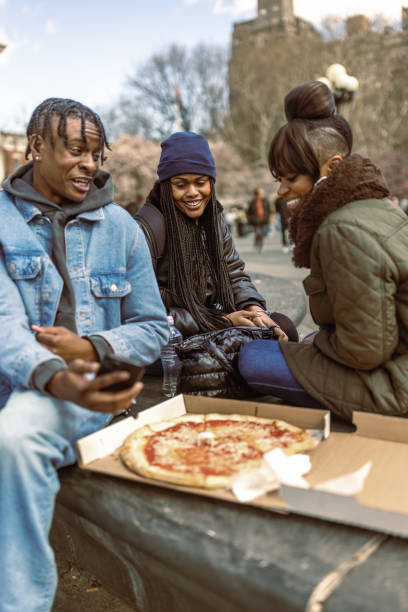 istock Friends Enjoying Pizza Outdoors on a Crisp Afternoon 2184841843
