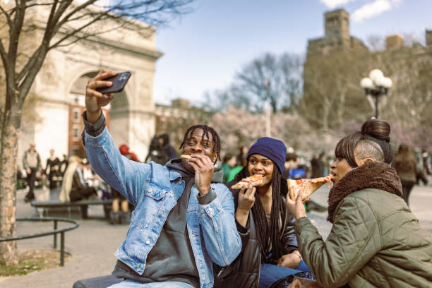 istock Friends Enjoying Pizza in Afternoon Washington Square Park 2184841883