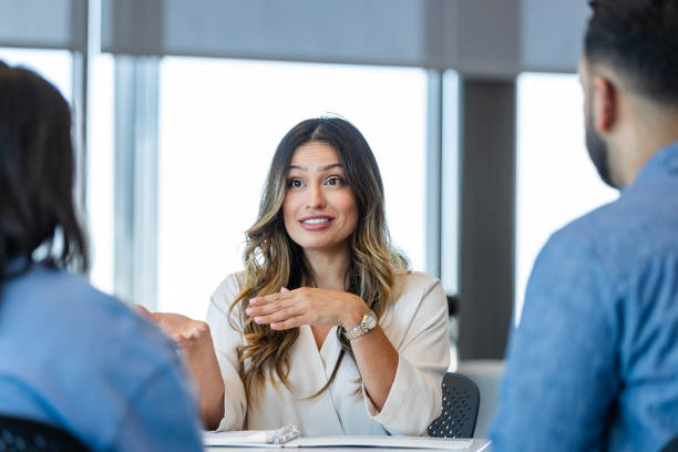 istock Female counselor meets with young couple 2184842032