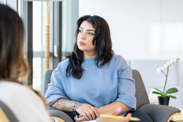 istock Sad young woman attends therapy session 2184842067