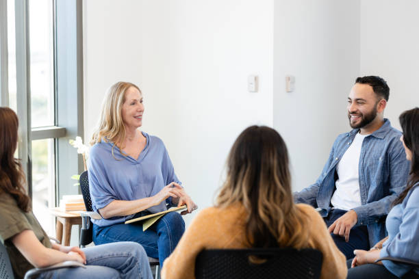 istock Group of people participate in support group 2184842089