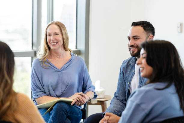 istock Cheerful people participate in support group meeting 2184842097
