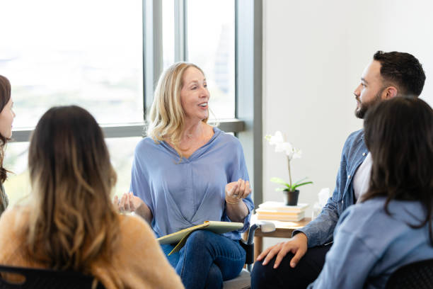 istock Caring mature therapist giving advice during group therapy session 2184842106