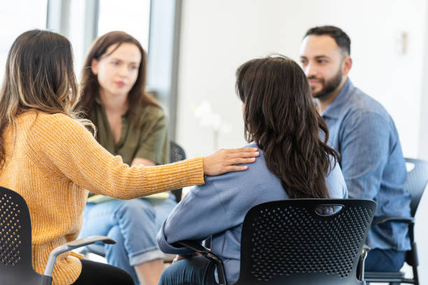 istock Woman shares something difficult during support group meeting 2184842114
